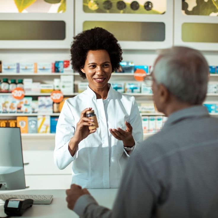 Pharmacist advising a patient at the counter